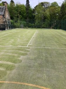 Before and after cleaning sand filled tennis court